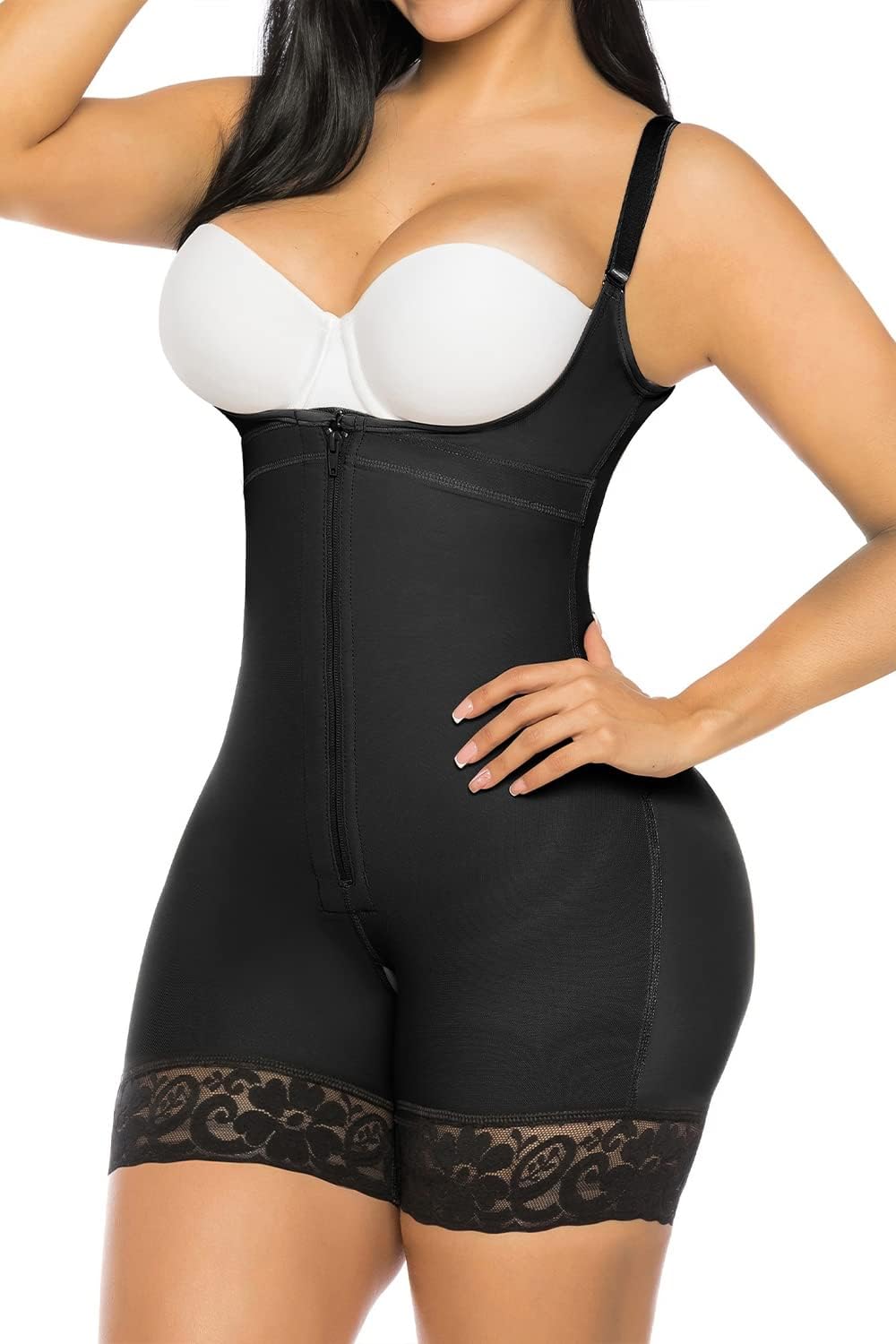 Woman wearing a black shapewear garment with lace details on a white background